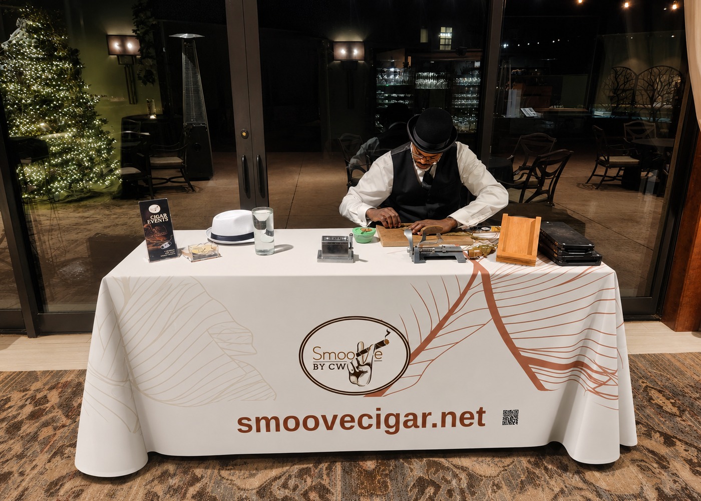 Professional cigar roller for corporate and private events at a SmooVe Cigar Brand rolling table